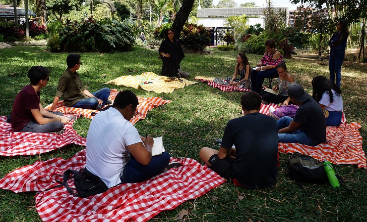 Imagen Mujeres indígenas en la Universidad de Ibagué sentadas sobre el césped del campus de Unibagué